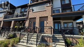 Ottawa townhouse for rent - A multi-story building with a brick facade and black railings.