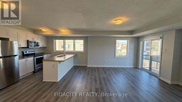 Ottawa townhouse for rent - A well-lit kitchen with stainless steel appliances and a large island.