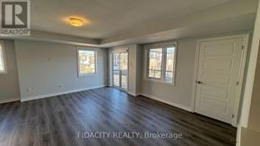 Ottawa townhouse for rent - A spacious room with wood flooring and two windows.