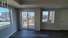 Ottawa townhouse for rent - A room with a view of a street and buildings outside the window.