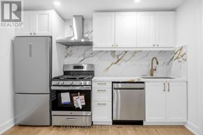 Toronto (Kensington-Chinatown) apartment for rent - A kitchen with a refrigerator, stove, and sink.