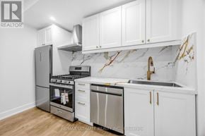 Toronto (Kensington-Chinatown) apartment for rent - A kitchen with white cabinets and marble countertops.
