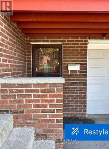 Toronto (Pleasant View) apartment for rent - A brick wall with a white door and a window.