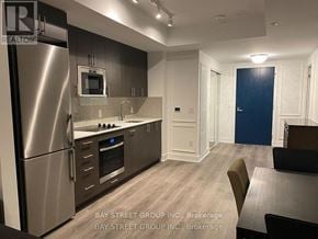 Oshawa (Windfields) condo for rent - A modern kitchen with a refrigerator, microwave, and oven.