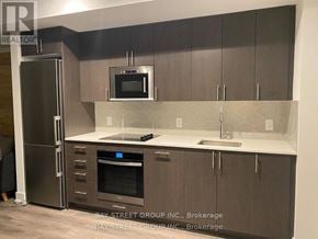 Oshawa (Windfields) condo for rent - A kitchen with a refrigerator, oven, and microwave.