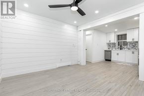 Toronto (The Beaches) multi-family for rent - A spacious room with a ceiling fan and lighting fixtures.