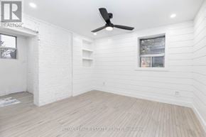 Toronto (The Beaches) multi-family for rent - A white room with a ceiling fan and wooden flooring.