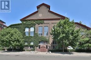 Toronto (Dovercourt-Wallace Emerson-Junction) condo for rent - A building with a red roof and ivy growing on it.