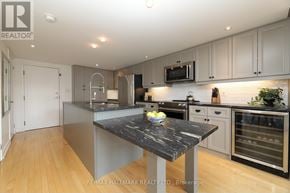 Toronto (Dovercourt-Wallace Emerson-Junction) condo for rent - A modern kitchen with a marble island in the center.