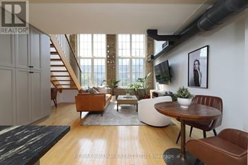 Toronto (Dovercourt-Wallace Emerson-Junction) condo for rent - A living room with a brown leather chair and a wooden table.