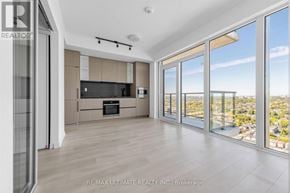Toronto (Dovercourt-Wallace Emerson-Junction) condo for rent - A spacious living room with a view of the cityscape outside the large windows.