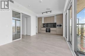 Toronto (Dovercourt-Wallace Emerson-Junction) condo for rent - A spacious kitchen with a large island and a view of the city.