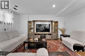Lasalle apartment for rent - A living room with a grey couch, a black coffee table, and a television.