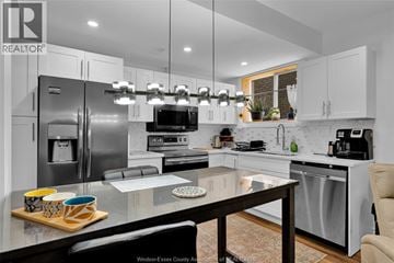 Lasalle apartment for rent - A modern kitchen with a glass table and stainless steel appliances.