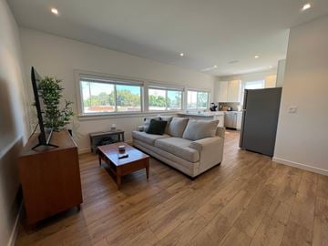 Long Beach apartment for rent - A living room with a couch, a coffee table, and a television.
