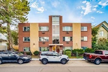 Denver apartment for rent - A modern apartment building with cars parked in front.