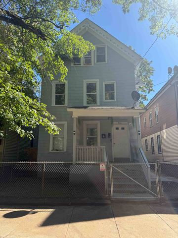 New Haven apartment for rent - A house with a grey front and a white door.