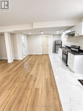 Orillia apartment for rent - A kitchen with a wooden floor and white walls.