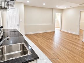 Orillia apartment for rent - A kitchen with a sink and wooden floors.