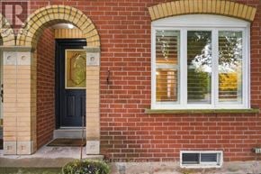Oakville (Wt West Oak Trails) townhouse for rent - A red brick house with a black door and a window.