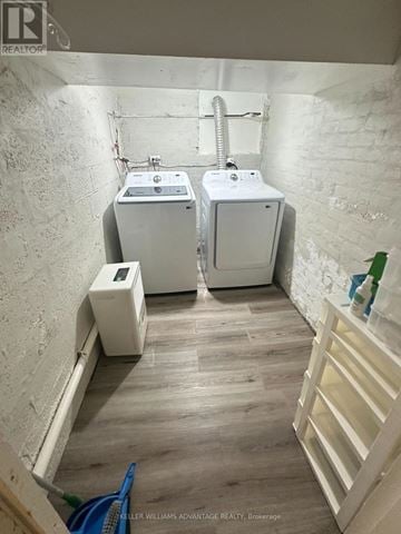 Toronto (The Beaches) triplex for rent - A bathroom with a toilet, sink, and a wall heater.
