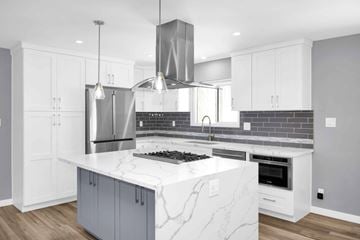 Signal Hill apartment for rent - A modern kitchen with a marble countertop and stainless steel appliances.