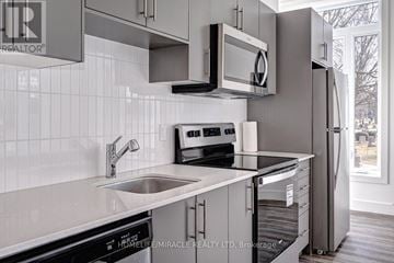 Waterloo condo for rent - A modern kitchen with a black oven and white cabinets.