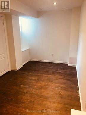 Mississauga (Central Erin Mills) apartment for rent - A room with wooden flooring and white walls.
