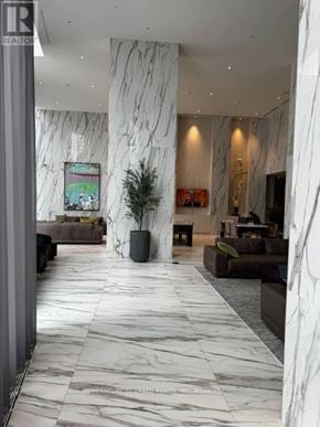 Mississauga (City Centre) condo for rent - A spacious lobby with marble floors and furniture.
