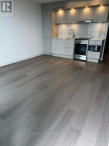 Mississauga (City Centre) condo for rent - A kitchen with a stove top oven and a microwave.