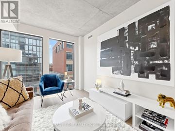 Toronto (Moss Park) condo for rent - A living room with a blue chair and a large painting on the wall.