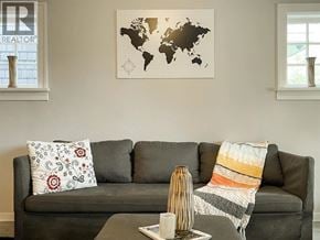 Vancouver apartment for rent - A grey couch with a world map on the wall behind it.