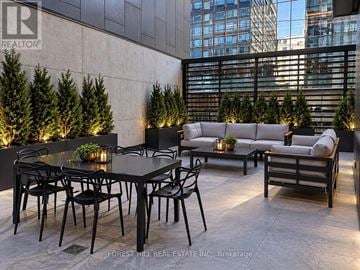 Toronto (Moss Park) condo for rent - A black table with chairs is set up on a patio.