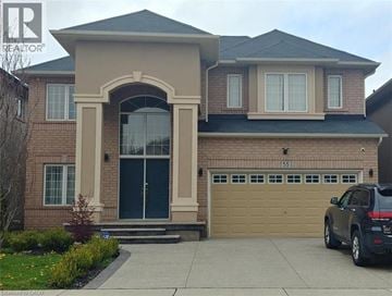 Ancaster apartment for rent - A house with a black car in front.