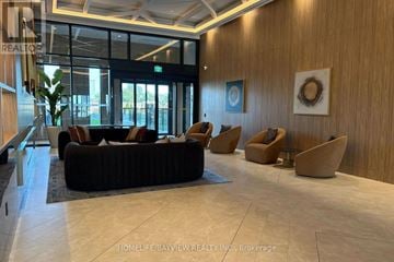 Vaughan (Vaughan Corporate Centre) condo for rent - A living room with a couch, chairs and a plant.