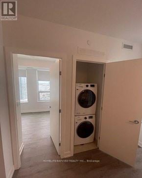 Vaughan (Vaughan Corporate Centre) condo for rent - A laundry room with a washer and dryer in it.