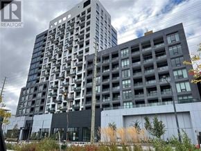 Richmond Hill (South Richvale) condo for rent - A modern apartment building with a glass facade stands tall against a cloudy sky.