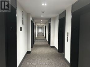 Richmond Hill (South Richvale) condo for rent - A long hallway with doors on both sides and a sign that says REALTOR.