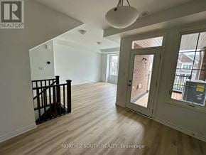 Barrie townhouse for rent - A room with a door leading outside and a window on the wall.