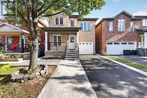 Brampton (Fletcher's Meadow) apartment for rent - A house with a driveway and a tree in front.