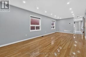 Brampton (Fletcher's Meadow) apartment for rent - A spacious room with wooden flooring and a window with red blinds.