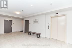 St. Catharines (Lakeport) condo for rent - A white hallway with a bench and a sign that says Elements.