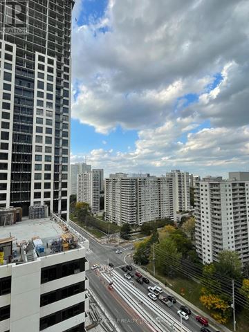 Mississauga (City Centre) condo for rent - A view of a cityscape with a highway and buildings.