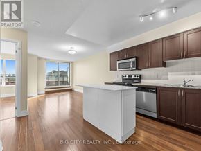 Toronto (York University Heights) condo for rent - A well-lit kitchen with wooden floors and white appliances.