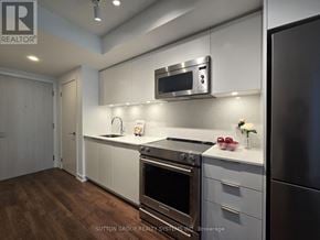 Toronto (Islington-City Centre West) condo for rent - A modern kitchen with a stainless steel refrigerator and oven.