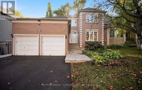 Mississauga (Sheridan) apartment for rent - A house with a brick facade and a white garage door is shown.