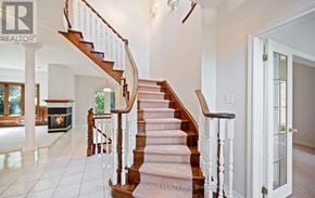 Mississauga (Sheridan) apartment for rent - A staircase with a wooden handrail and a white balustrade leads to a second floor.