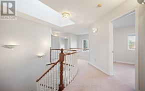 Mississauga (Sheridan) apartment for rent - A spacious room with a wooden staircase and white walls.