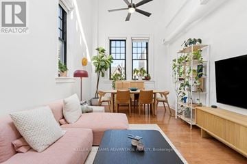 Toronto (Palmerston-Little Italy) condo for rent - A living room with a pink couch and a television on a stand.
