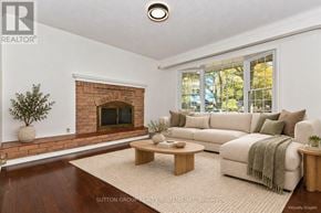 St. Catharines (Lakeport) apartment for rent - A living room with a fireplace and a couch.